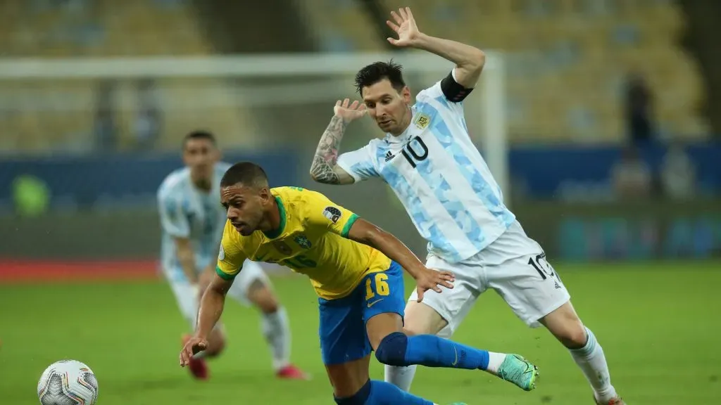 Renan Lodi of Brazil fights for the ball with Lionel Messi during the 2021 Copa America final in Brazil.