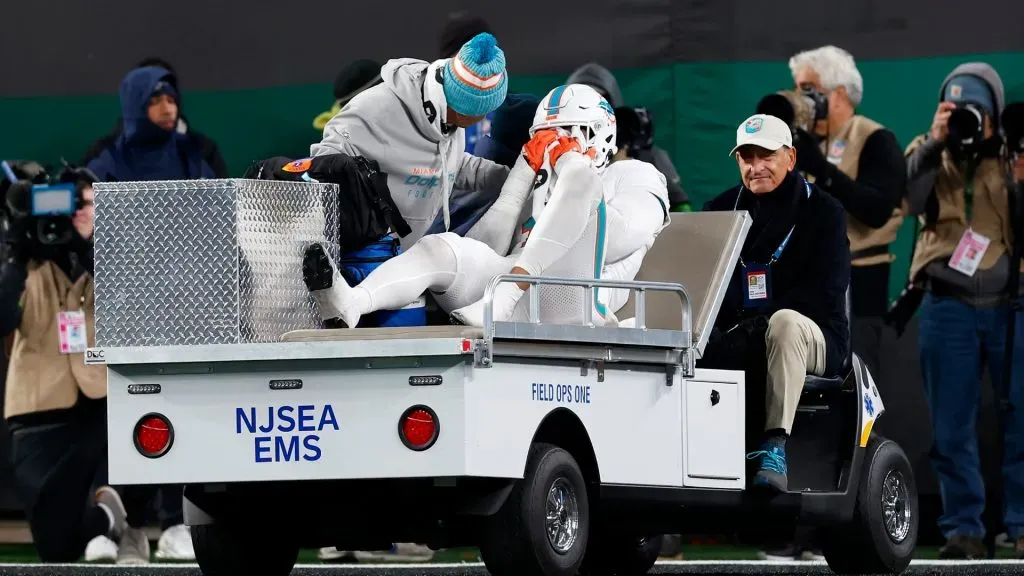 Jaelan Phillips is carted off the field after being injured in a play against the Jets. (Getty Images)