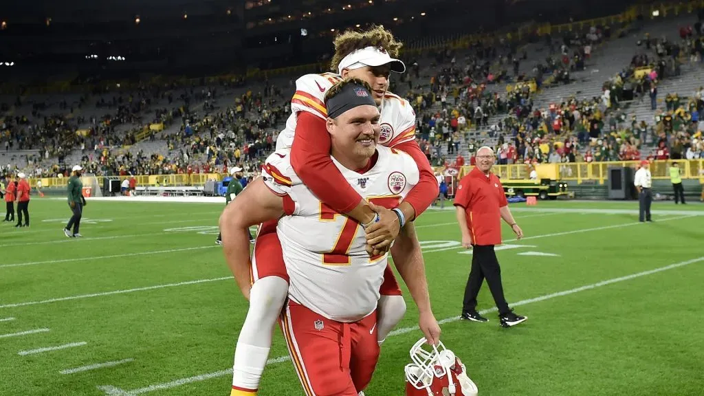 Patrick Mahomes is escorted off the field on the back of Andrew Wylie after a preseason game against the Green Bay Packers at Lambeau Field on August 29, 2019 in Green Bay, Wisconsin.