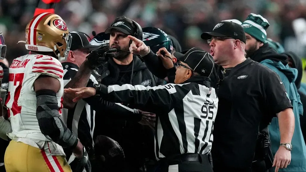 Dre Greenlaw #57 of the San Francisco 49ers exchanges words with Philadelphia Eagles head coach Nick Sirianni and Dom DiSandro at Lincoln Financial Field on December 03, 2023 in Philadelphia, Pennsylvania.