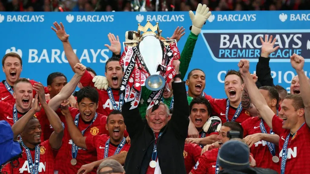 Manchester United Manager Sir Alex Ferguson lifts the Premier League trophy in 2013.