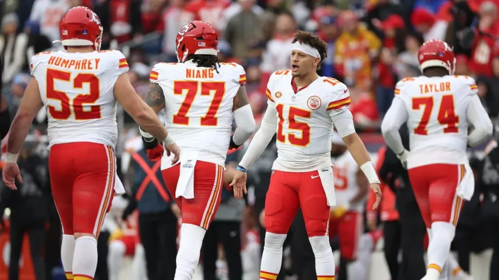 Patrick Mahomes #15 of the Kansas City Chiefs high fives teammates during the third quarter against the New England Patriots at Gillette Stadium on December 17, 2023 in Foxborough, Massachusetts.