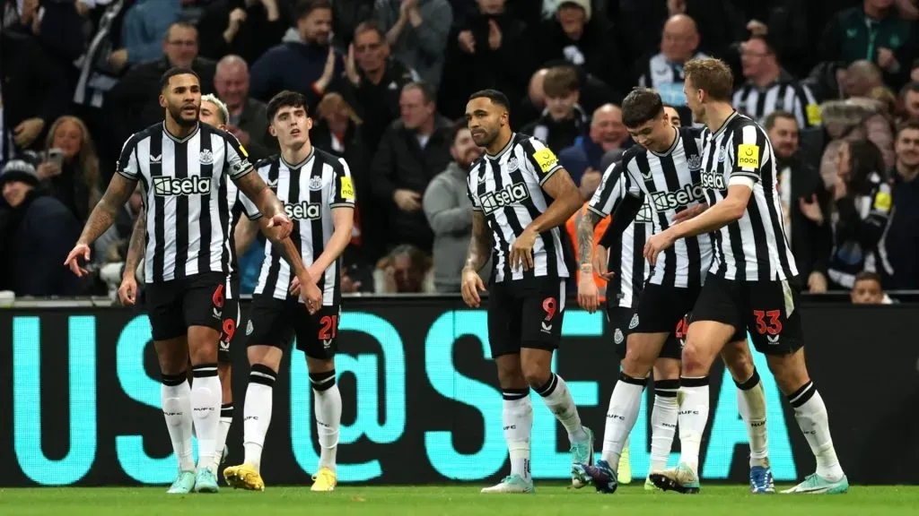 Lewis Miley of Newcastle United (R) celebrates with teammates after scoring their team’s first goal during the Premier League match between Newcastle United and Fulham FC at St. James Park on December 16, 2023 in Newcastle upon Tyne, England.