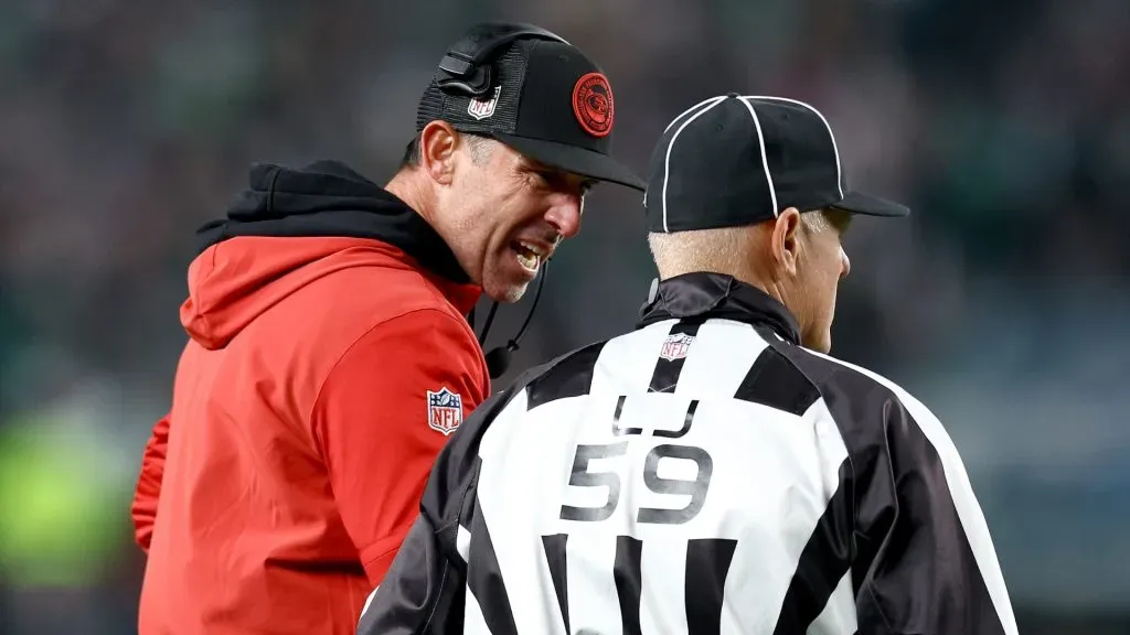 49ers head coach Kyle Shanahan speaks with line judge Rusty Baynes #59 during the third quarter in the game against the Philadelphia Eagles at Lincoln Financial Field on December 03, 2023 in Philadelphia, Pennsylvania.