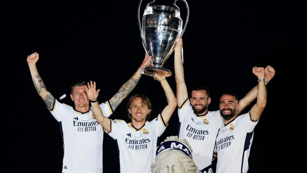 Toni Kroos, Luka Modric, Nacho Fernandez and Daniel Carvajal of Real Madrid celebrate with the UEFA Champions League trophy during the Real Madrid UEFA Champions League Trophy Parade in 2024. (Source: Angel Martinez/Getty Images)