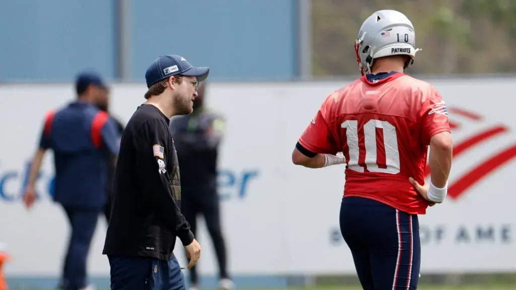 New England Patriots safeties coach Brian Belichick talks to quarterback Mac Jones (10) during New England Patriots Minicamp on June 12, 2023, at the Patriots Practice Facility at Gillette Stadium in Foxborough, Massachusetts.