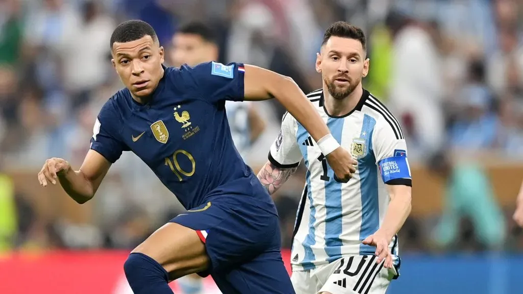 Kylian Mbappe battles for possession with Lionel Messi in the 2022 World Cup final.