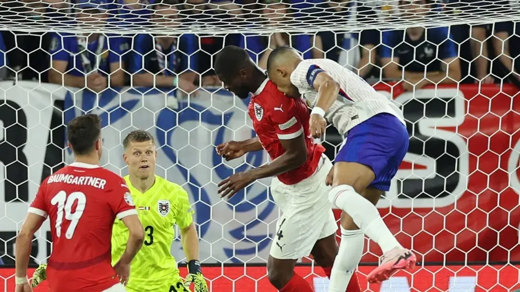 Kylian Mbappe of France clashes heads with Kevin Danso of Austria during the UEFA EURO 2024 group stage match between Austria and France at Düsseldorf Arena on June 17, 2024 in Dusseldorf, Germany.