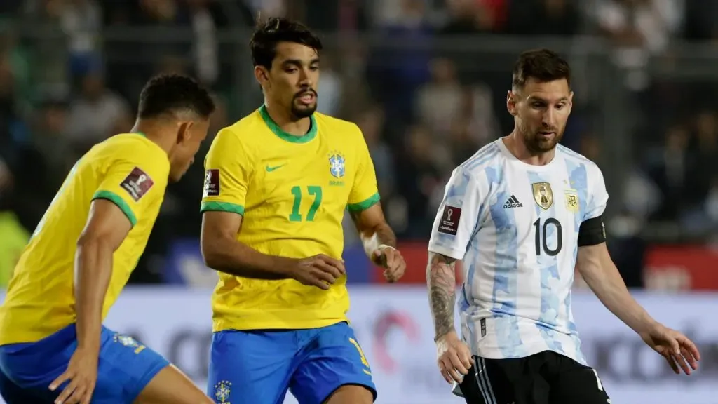 Lionel Messi competes for the ball with Lucas Paquetá (C) and Danilo da Silva (L) during a match in 2021.