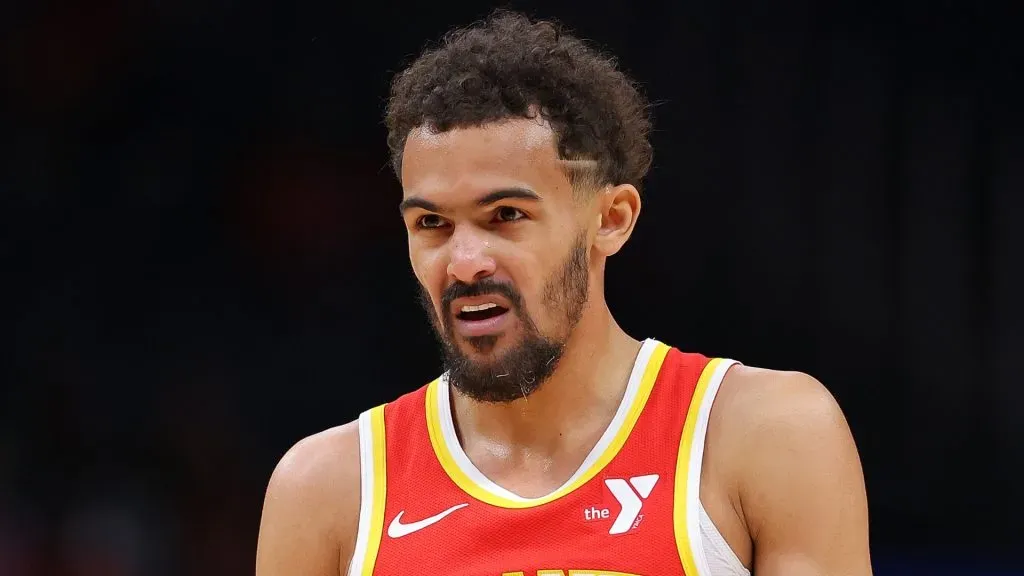 Trae Young #11 of the Atlanta Hawks grabs his wrapped finger after drawing a foul against the Charlotte Hornets during the first quarter at State Farm Arena on April 10, 2024 in Atlanta, Georgia.