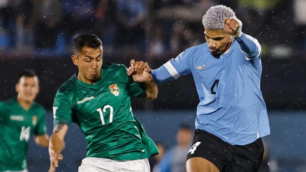 Roberto Fernandez (L) of Bolivia struggles for the ball against Ronald Araujo (R) of Uruguay during the FIFA World Cup 2026 Qualifier match between Uruguay and Bolivia at Centenario Stadium on November 21, 2023 in Montevideo, Uruguay.