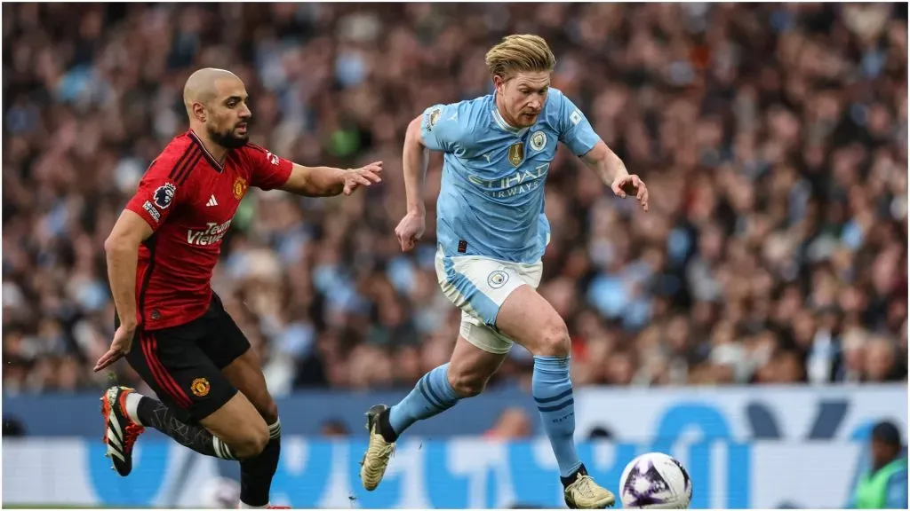 Kevin De Bruyne of Manchester City breaks with
the ball tracked by Sofyan Amrabat of Manchester United