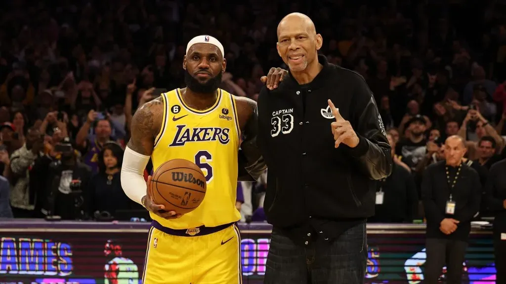 Kareem Abdul-Jabbar stands on court with LeBron James #6 of the Los Angeles Lakers after James passed Abdul-Jabbar to become the NBA’s all-time leading scorer. Harry How/Getty Images