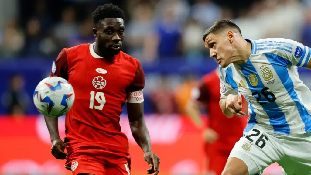 Alphonso Davies of Canada battles for possession with Nahuel Molina of Argentina during the CONMEBOL Copa America group A match between Argentina and Canada at Mercedes-Benz Stadium on June 20, 2024 in Atlanta, Georgia.