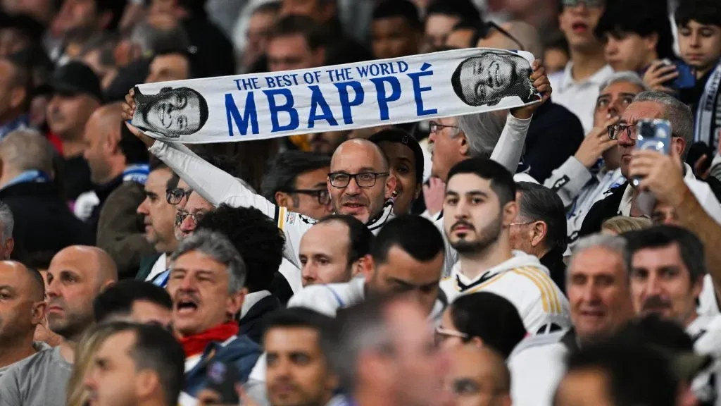 An eal Madrid fan holds a Mbappe scarf up during the UEFA Champions League quarter-final first leg match between Real Madrid CF and Manchester City at Estadio Santiago Bernabeu on April 09, 2024 in Madrid, Spain. Photo by David Ramos/Getty Images