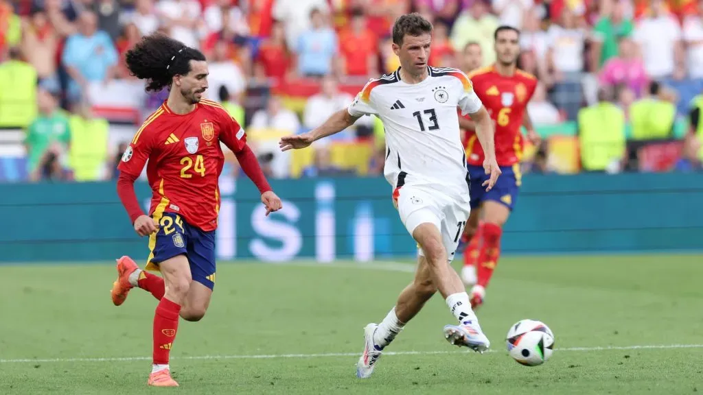 Thomas Mueller of Germany passes the ball under pressure from Marc Cucurella of Spain during the UEFA EURO 2024 quarter-final match between Spain and Germany. Alexander Hassenstein/Getty Images