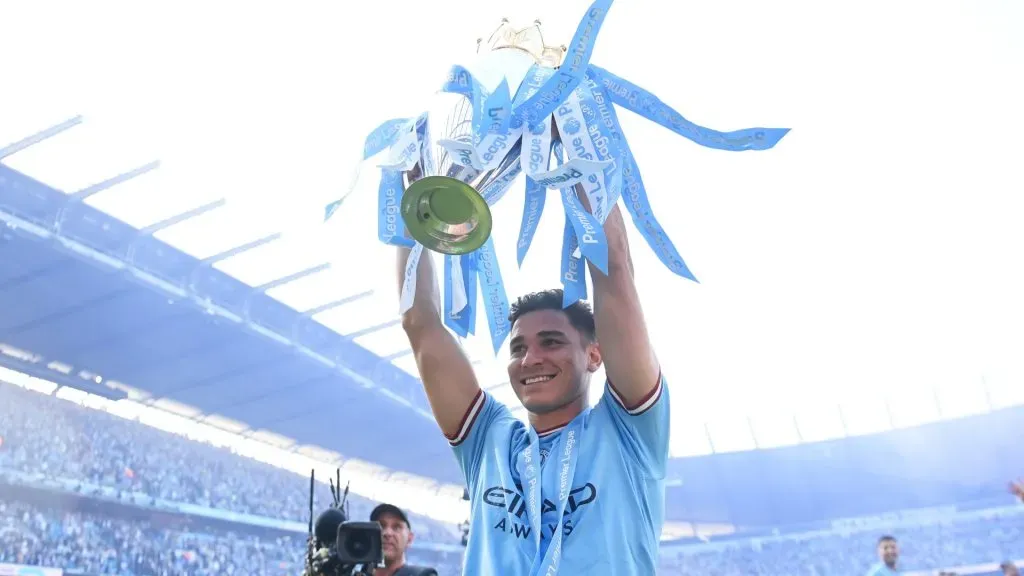 Julian Alvarez of Manchester City celebrates with the Premier League trophy following the Premier League match between Manchester City and Chelsea FC at Etihad Stadium on May 21, 2023 in Manchester, England.