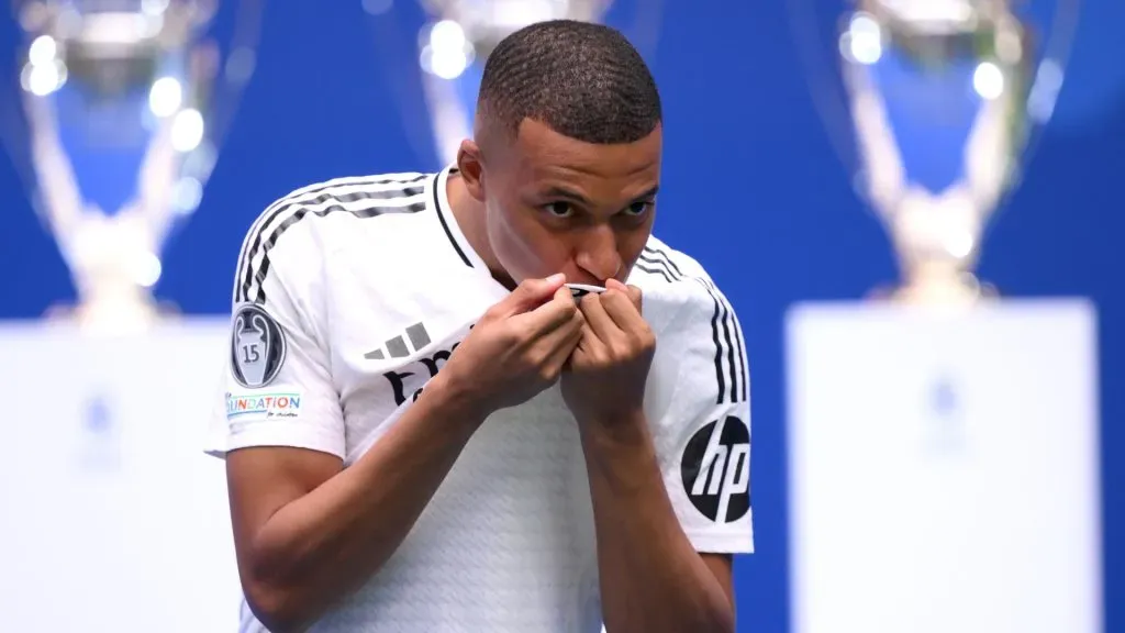 Real Madrid new signing, Kylian Mbappe kisses the Real Madrid badge as he is unveiled at Estadio Santiago Bernabeu on July 16, 2024 in Madrid, Spain. (Photo by David Ramos/Getty Images)