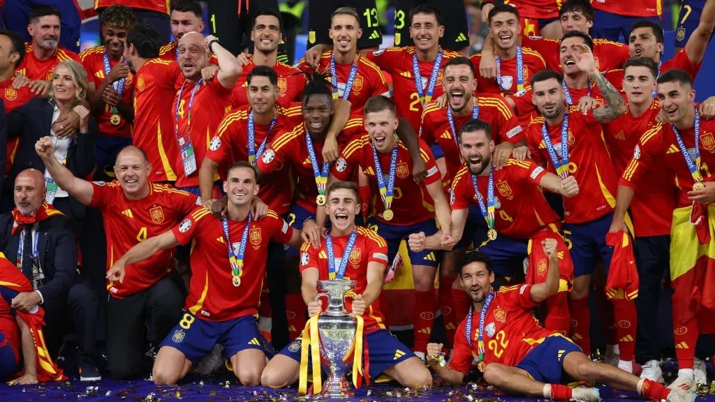 Players of Spain pose for a photo with the UEFA Euro 2024 Henri Delaunay Trophy after victory over England in the UEFA EURO 2024 final match between Spain and England at Olympiastadion on July 14, 2024 in Berlin, Germany. Photo by Lars Baron/Getty Images