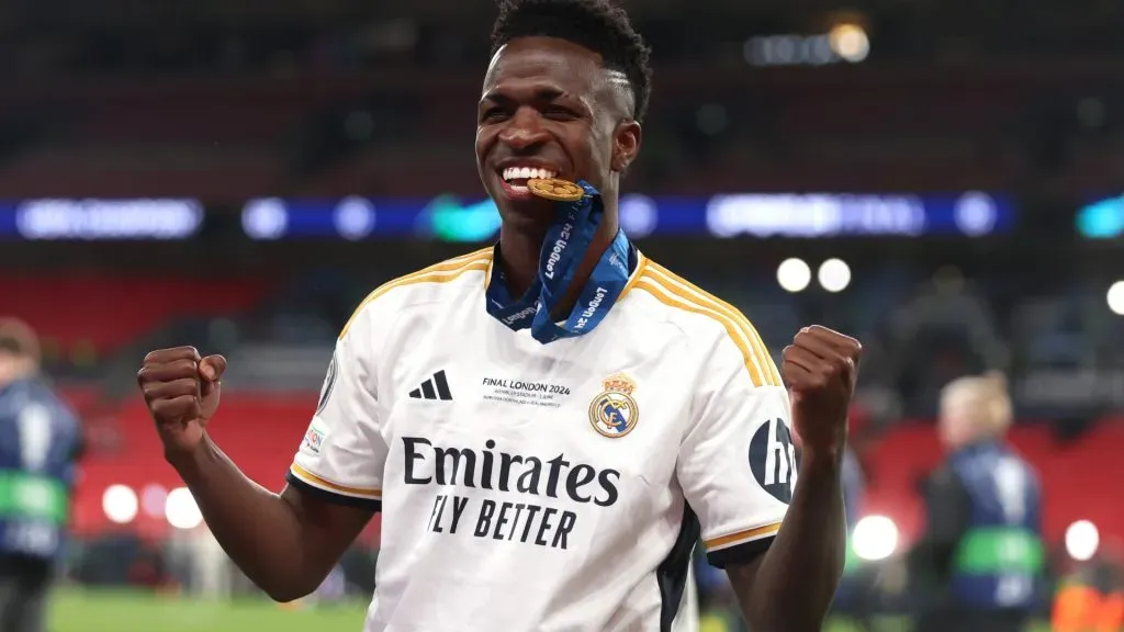 Vinicius Junior of Real Madrid bites his winners medal following victory in the UEFA Champions League 2023/24 Final match between Borussia Dortmund and Real Madrid CF at Wembley Stadium on June 01, 2024 in London, England.