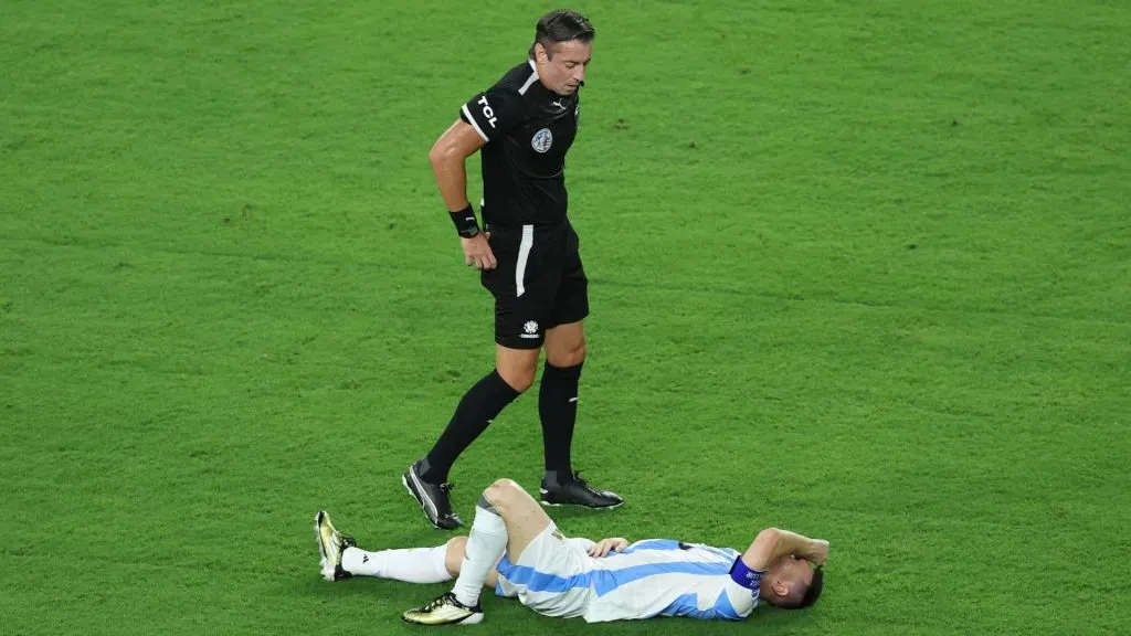 Lionel Messi of Argentina lies on the grass with an injury during the CONMEBOL Copa America 2024 Final match between Argentina and Colombia. Megan Briggs/Getty Images