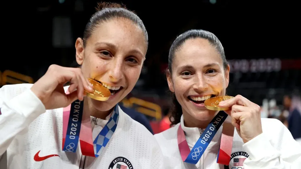 Diana Taurasi and Sue Bird of Team United States bite their gold medals during the Women’s Basketball medal ceremony of the 2020 Tokyo Olympic games. Kevin C. Cox/Getty Images