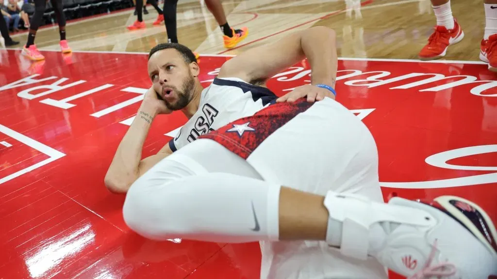 Stephen Curry #4 of the United States strikes a pose as he falls out of bounds after making a basket and drawing a foul against Shai Gilgeous-Alexander #2 of Canada in the second half of their exhibition game ahead of the Paris Olympic Games at T-Mobile Arena on July 10, 2024 in Las Vegas, Nevada. The United States defeated Canada 86-72.
