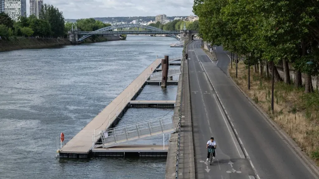 A member of the public rides his bike on a empty Voie Georges Pompidou avenue along the Seine River ahead of the Opening Ceremony of the Paris 2024 Olympic Games on July 22, 2024 in Paris, France. (Photo by David Ramos/Getty Images)