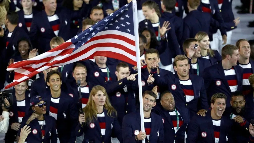 Flag bearer Michael Phelps of the United States and Ibtihaj Muhammad lead the U.S. Olympic Team during the Opening Ceremony of the Rio 2016 Olympic Games at Maracana Stadium on August 5, 2016 in Rio de Janeiro, Brazil. (Photo by Buda Mendes/Getty Images)