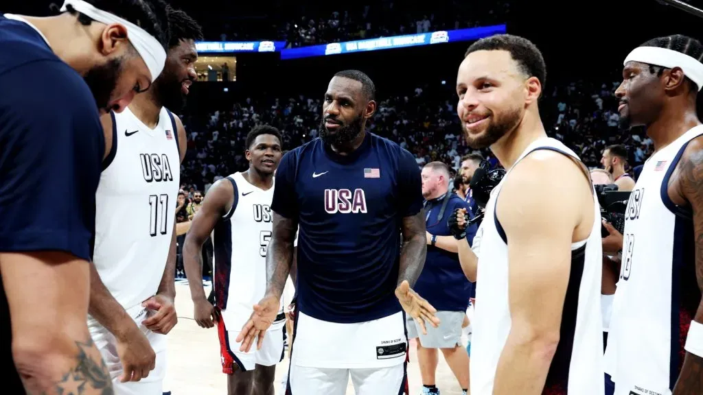 (L-R) Anthony Davis #14, Joel Embiid #11, Anthony Edwards #5, LeBron James #6, Stephen Curry #4 and Nigel Hayes-Davis #1 of the United States gather after an exhibition game between the United States and Serbia ahead of the Paris Olympic Games at Etihad Arena on July 17, 2024 in Abu Dhabi, United Arab Emirates. (Photo by Christopher Pike/Getty Images)