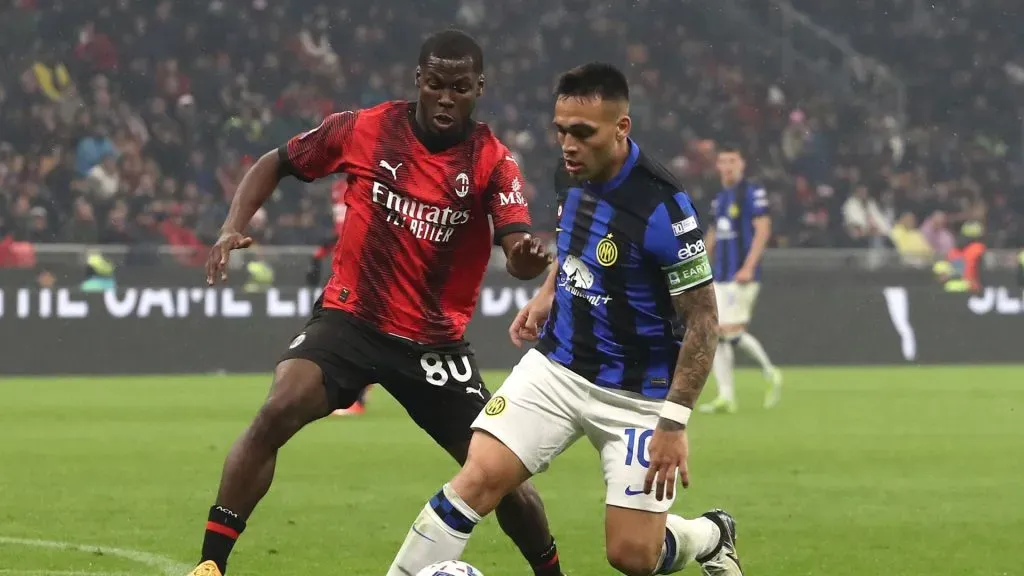 Lautaro Martinez of FC Internazionale is pressured by Yunus Musah of AC Milan during the Serie A TIM match between AC Milan and FC Internazionale at Stadio Giuseppe Meazza on April 22, 2024 in Milan, Italy.
