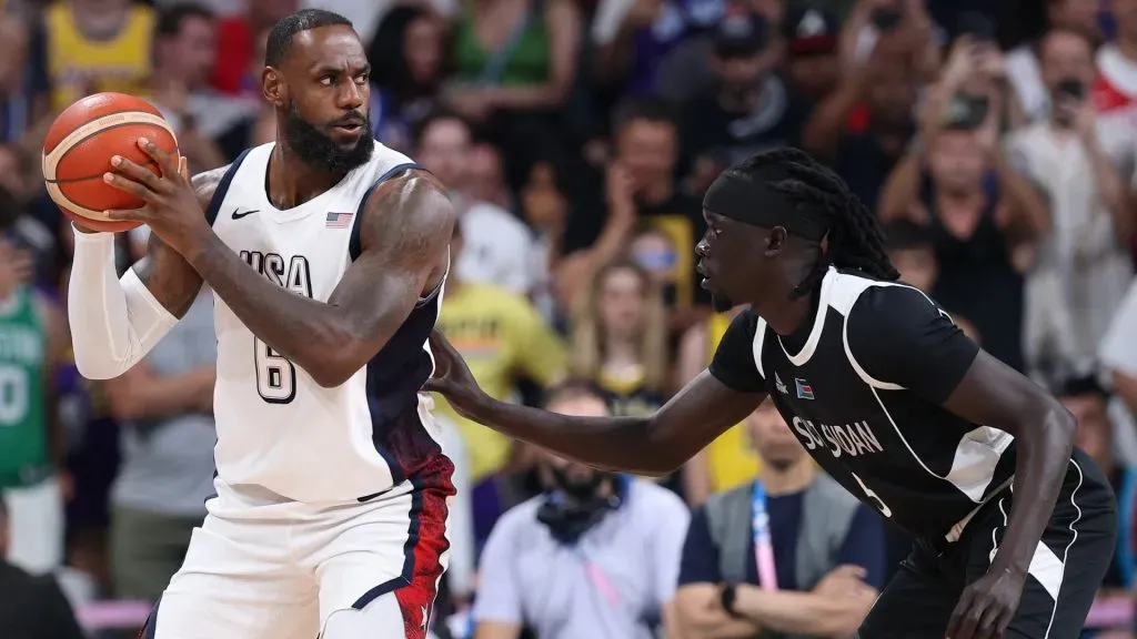 Lebron James #6 of Team United States holds the ball while defended by Nuni Omot #5 of Team South Sudan during a Men’s Group Phase – Group C game between United States and South Sudan on day five of the Olympic Games Paris 2024 at Stade Pierre Mauroy on July 31, 2024 in Lille, France. (Photo by Gregory Shamus/Getty Images)