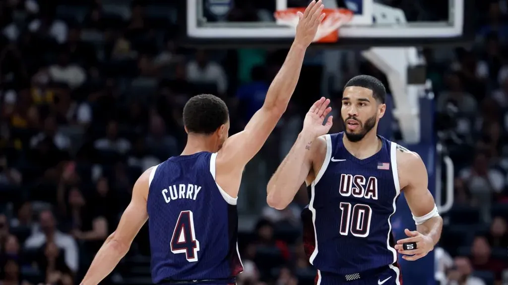 Jayson Tatum #10 and Stephen Curry #4 of the United States react during the first half of an exhibition game between the United States and Australia ahead of the Paris Olympic Games at Etihad Arena on July 15, 2024 in Abu Dhabi, United Arab Emirates. (Photo by Christopher Pike/Getty Images)