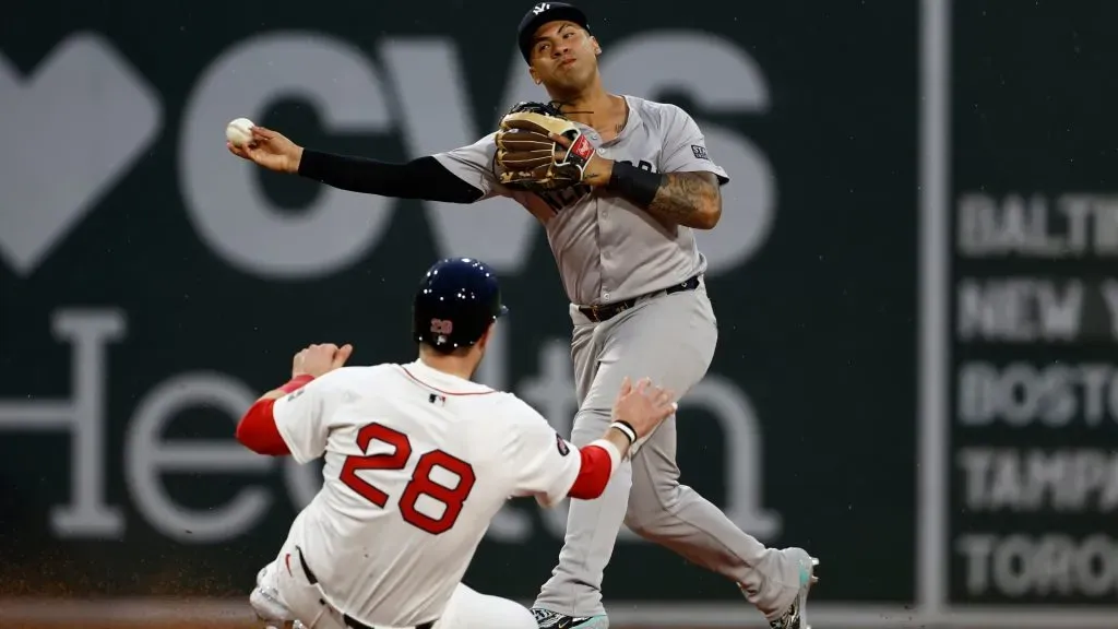 Gleyber Torres #25 of the New York Yankees throws over Danny Jansen #28 of the Boston Red Sox but could not complete the double play during the third inning at Fenway Park. (Photo By Winslow Townson/Getty Images)