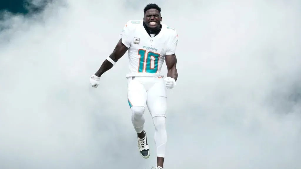 Tyreek Hill #10 of the Miami Dolphins runs onto the field during team introductions prior to the game against the Las Vegas Raiders at Hard Rock Stadium on November 19, 2023 in Miami Gardens, Florida.