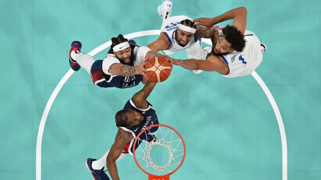 Kevin Durant #7 and Anthony Davis #14 of Team United States contest for a rebound over Jose Alvarado #10 and George Conditt IV #1 of Team Puerto Rico. Pool/Getty Images