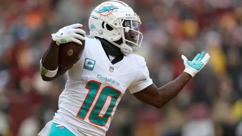 Wide receiver Tyreek Hill #10 of the Miami Dolphins celebrates after catching a touchdown pass againstthe Washington Commanders in the second half at FedExField on December 03, 2023 in Landover, Maryland.