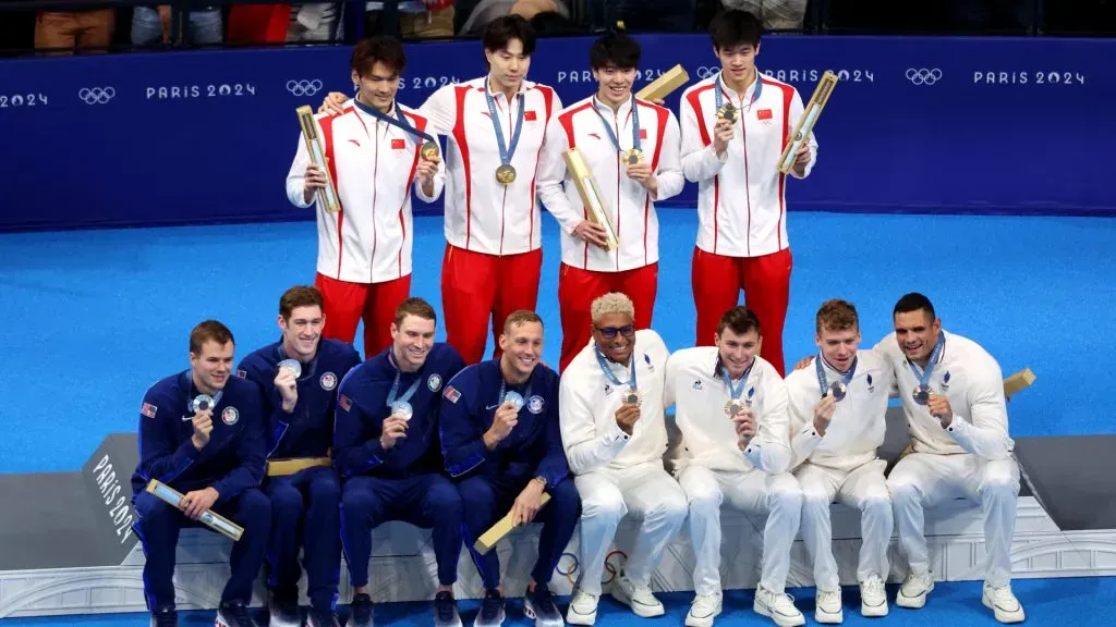 Gold Medalists of Team People’s Republic of China, Silver Medalists of Team United States and Bronze Medalists of Team France pose on the podium during the Swimming medal ceremony after the Men’s 4x100m Medley Relay Final