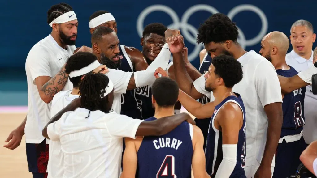 Lebron James #6 of Team United States, left with arm sleeve, huddles with members of Team United States after their victory against Team Brazil. Michael Reaves/Getty Images