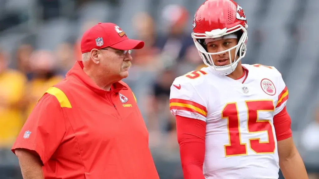 Head coach Andy Reid and Patrick Mahomes #15 of the Kansas City Chiefs talk prior to a preseason game against the Chicago Bears at Soldier Field on August 13, 2022 in Chicago, Illinois.