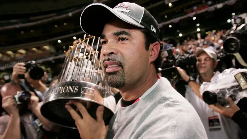 Manager Ozzie Guillen #13 of the Chicago White Sox celebrates with the Championship trophy after winning Game Four of the 2005 Major League Baseball World Series against the Houston Astros at Minute Maid Park. (Photo by Jed Jacobsohn/Getty Images)