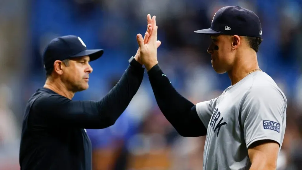 Manager Aaron Boone #17 and Aaron Judge #99 of the New York Yankees celebrate a 2-1 win over the Tampa Bay Rays at Tropicana Field. (Photo by Douglas P. DeFelice/Getty Images)