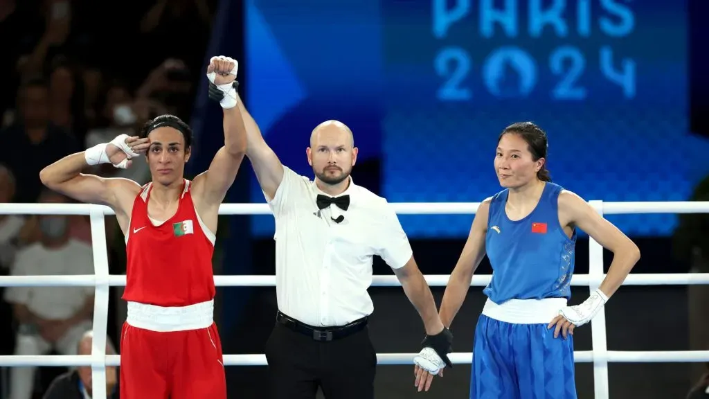 Liu Yang of Team China looks on as Match Referee Jakov Peterson raises the hand of Imane Khelif of Team Algeria to announce the winner of the Boxing Women’s 66kg. Maja Hitij/Getty Images