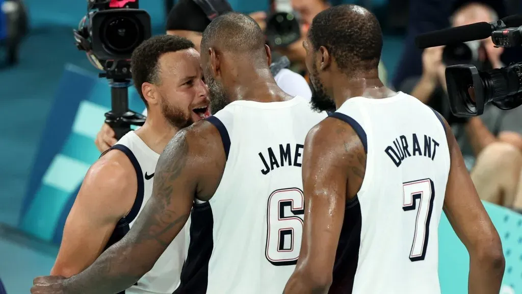 Lebron James #6 and Stephen Curry #4 of Team United States react after winning a Men’s basketball semifinals match between Team United States and Team Serbia on day thirteen of the Olympic Games Paris 2024 at Bercy Arena on August 08, 2024 in Paris, France.