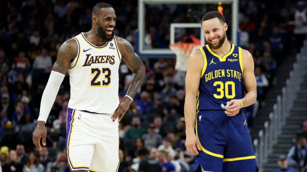 Stephen Curry #30 of the Golden State Warriors and LeBron James #23 of the Los Angeles Lakers joke around with one another during their game at Chase Center on January 27, 2024 in San Francisco, California.