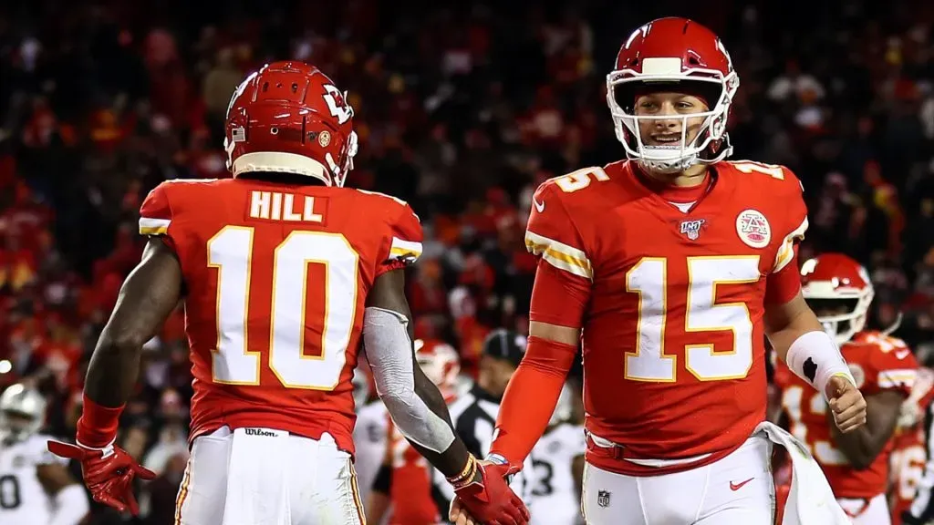 Quarterback Patrick Mahomes #15 of the Kansas City Chiefs is congratulated by wide receiver Tyreek Hill #10 after a touchdown during the 4th quarter of the game against the Oakland Raiders at Arrowhead Stadium on December 01, 2019 in Kansas City, Missouri.