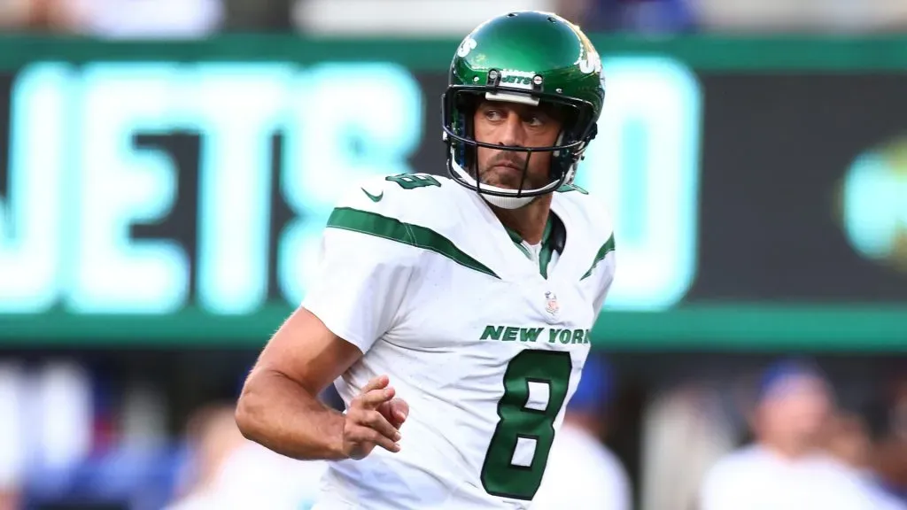 Aaron Rodgers #8 of the New York Jets reacts after throwing a first quarter touchdown pass to Garrett Wilson #17 in a preseason game against the New York Giants at MetLife Stadium on August 26, 2023 in East Rutherford, New Jersey.