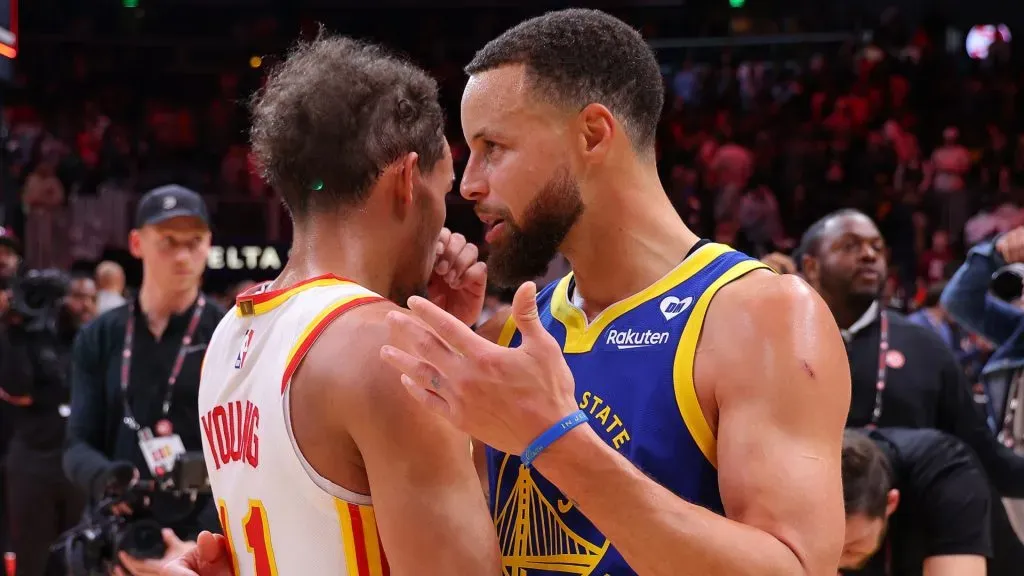 Stephen Curry #30 of the Golden State Warriors converses with Trae Young #11 of the Atlanta Hawks. Kevin C. Cox/Getty Images