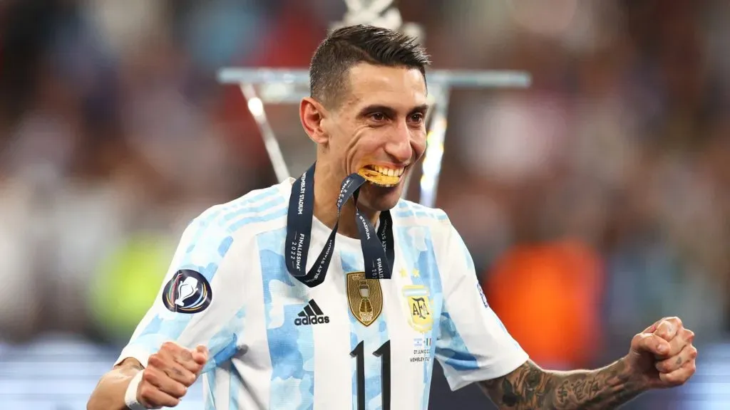 Angel Di Maria of Argentina bites on their winners medal as they walk to the podium after the final whistle of the 2022 Finalissima match between Italy and Argentina at Wembley Stadium on June 01, 2022 in London, England.