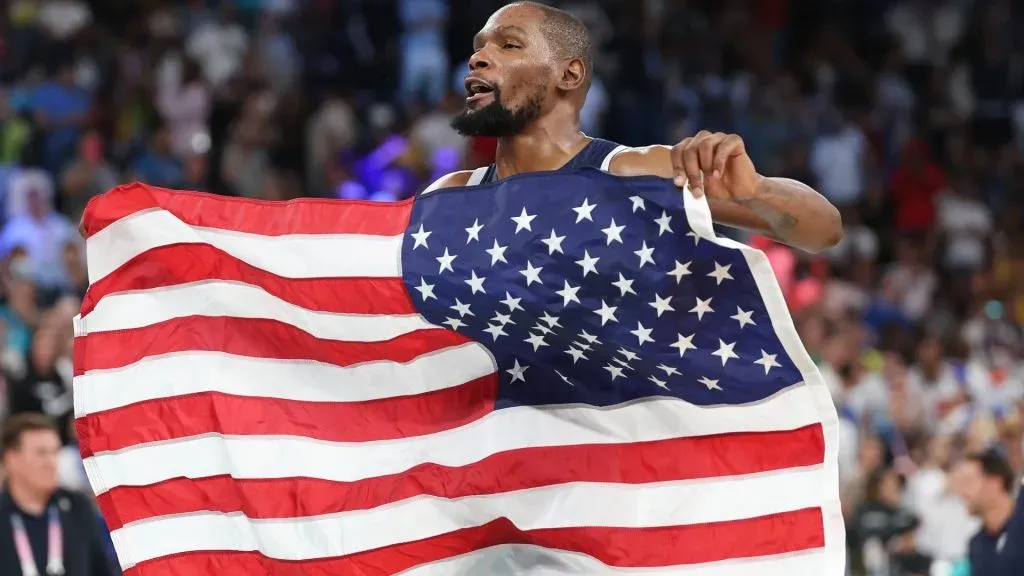 Kevin Durant #7 of Team United States reacts with the American Flag after his team’s victory against Team France during the Men’s Gold Medal game between Team France and Team United States on day fifteen of the Olympic Games Paris 2024 at Bercy Arena on August 10, 2024 in Paris, France. (Photo by Michael Reaves/Getty Images)